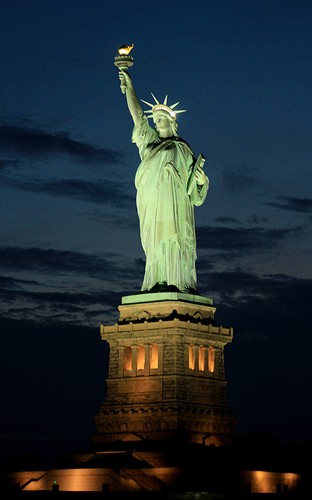 Bateaux New York dîner-croisière sur le pont du bâteau vue sur la Statue de la Liberté à la tombée de la nuit