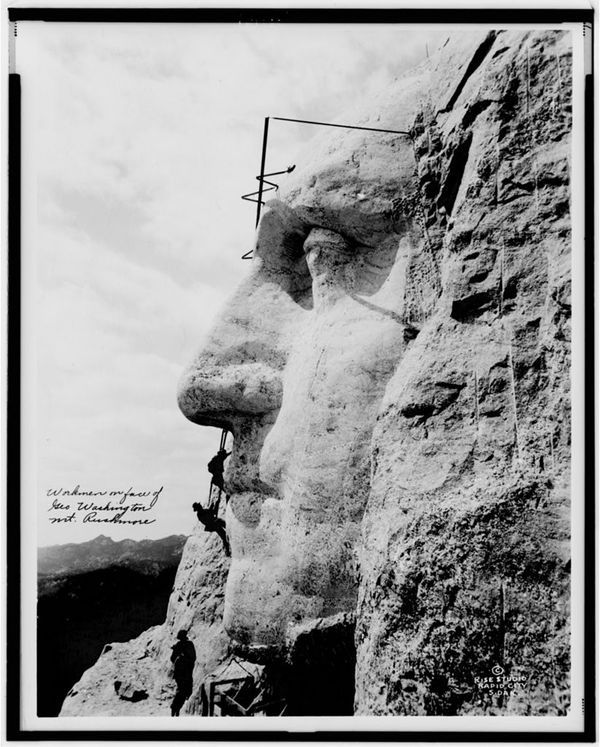 Workmen on face of George Washington, Mt. Rushmore
